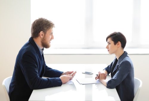 Businessman and businesswoman having interview in the office