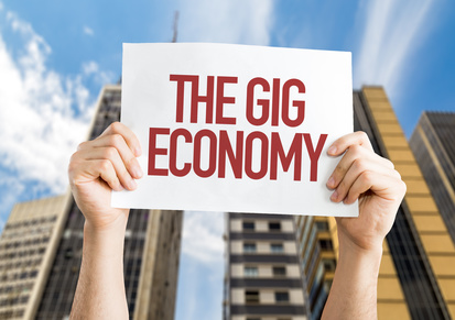 The GIG Economy placard with urban background